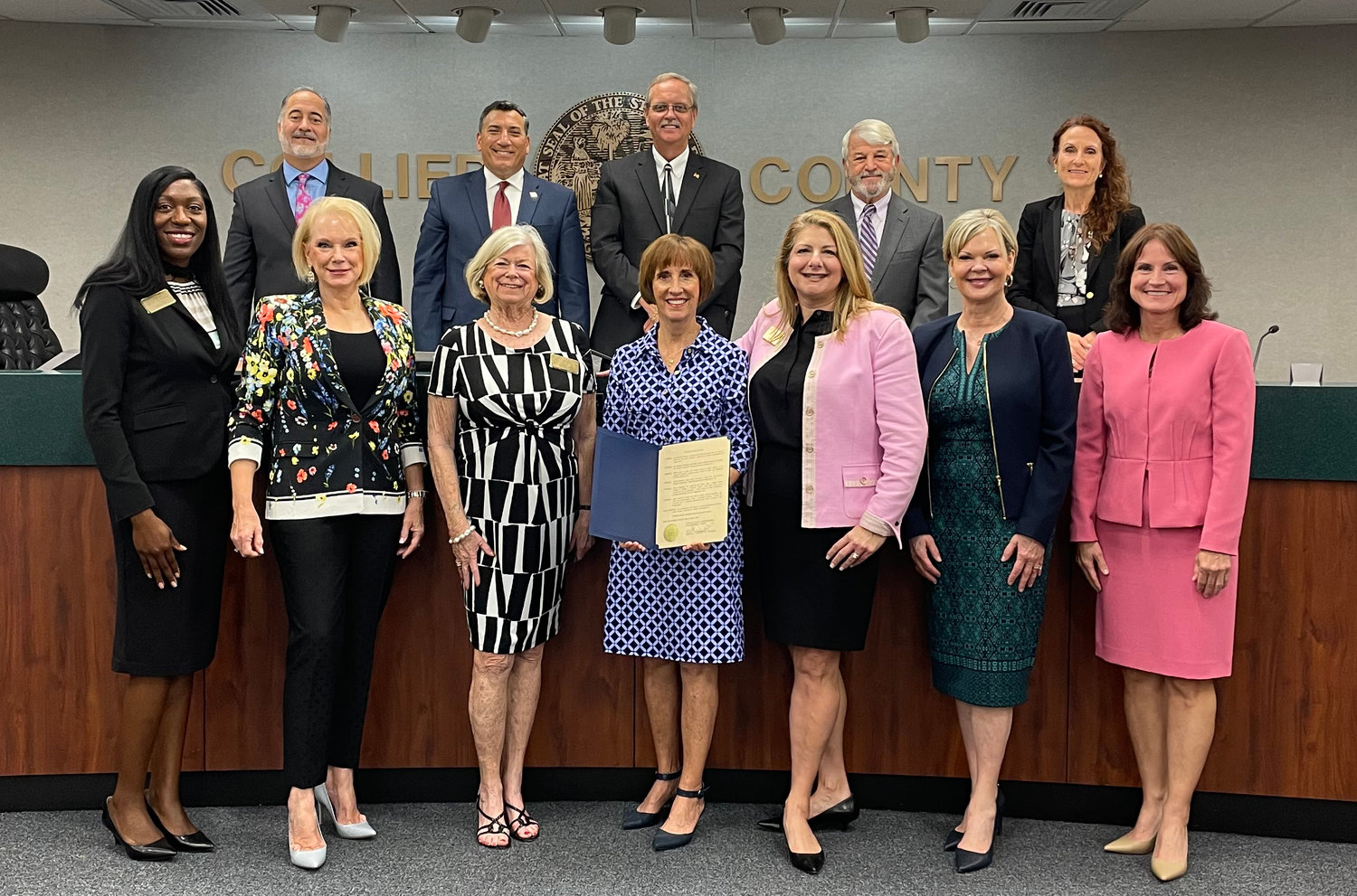 Pictured in the front row from left to right are Althea Irving, Brenda O’Connor, Bette Aymar, Donna Messer, Lori Fowler, Lynda Waterhouse, and Michelle McLeod. Pictured in the back row from left to right are Collier County Commissioners Andy Solis, Rick Lo Castro, Bill McDaniel, Burt Saunders, and Penny Taylor.